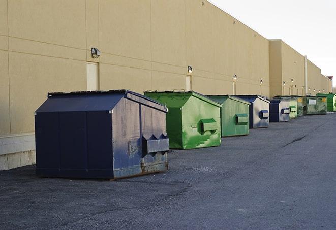 construction workers toss wood scraps into a dumpster in Alsip